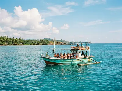 Whale watching boat on turquoise Indian Ocean off Mirissa beach