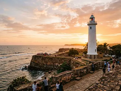 Galle Fort lighthouse at golden hour with colonial ramparts and ocean